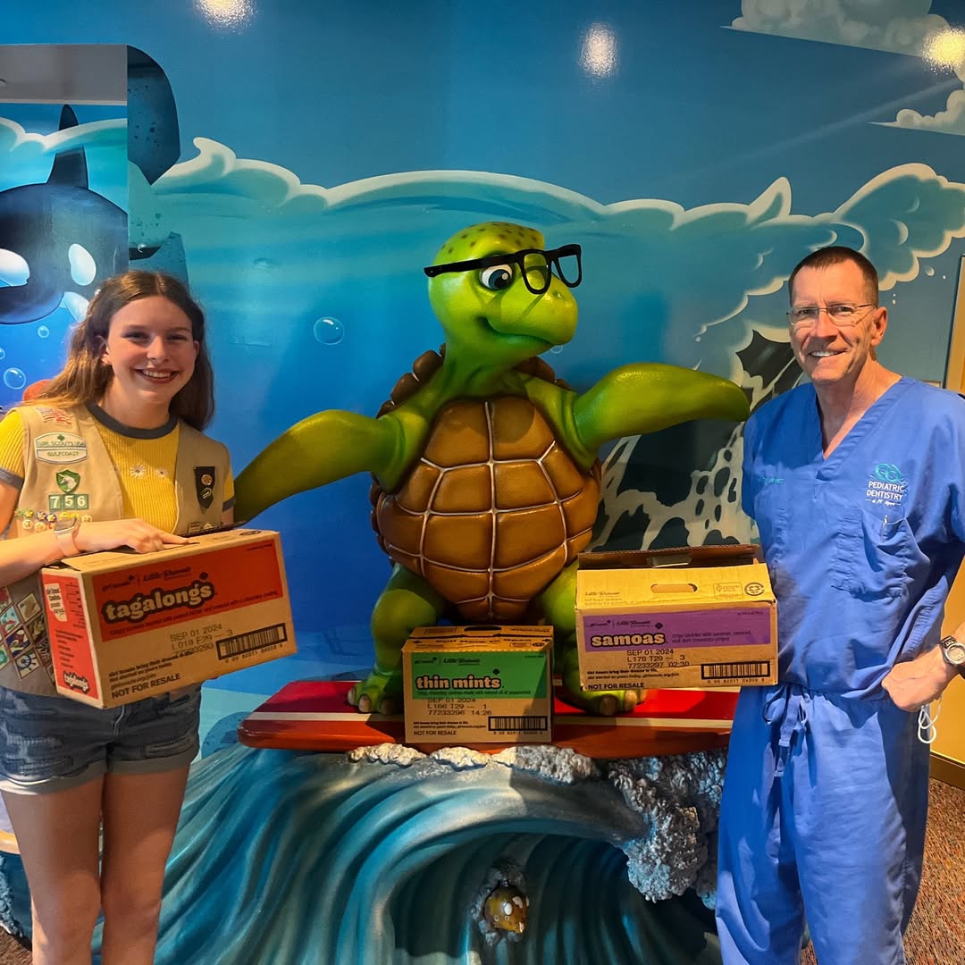 Dr. Verwest supporting a Girl Scout cookie seller at the office