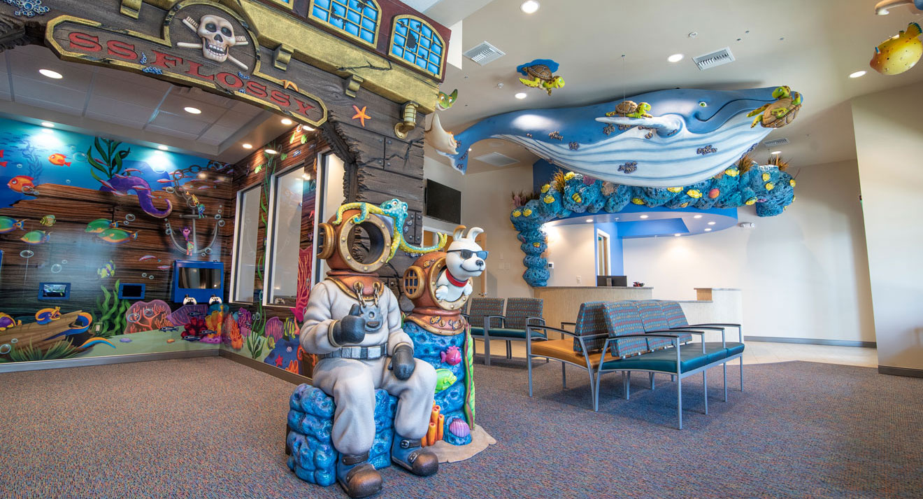 Naples lobby with the S.S. Flossy pirate ship, deep-sea diver statue with Shades, and a blue whale overhead
