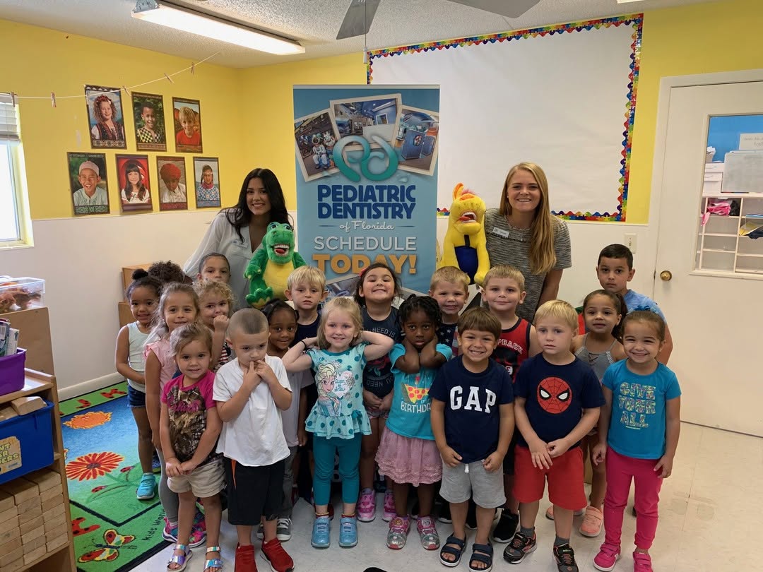 Team member teaching a preschool class about dental health