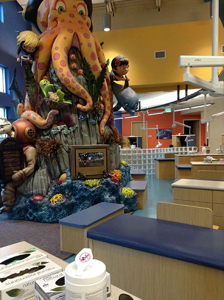 Giant orange octopus sculpture over the open treatment bay