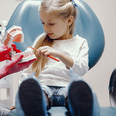 Little girl in pediatric dentist's chair